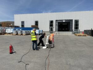team member from itw gse putting out a fire during a fire fighting drill