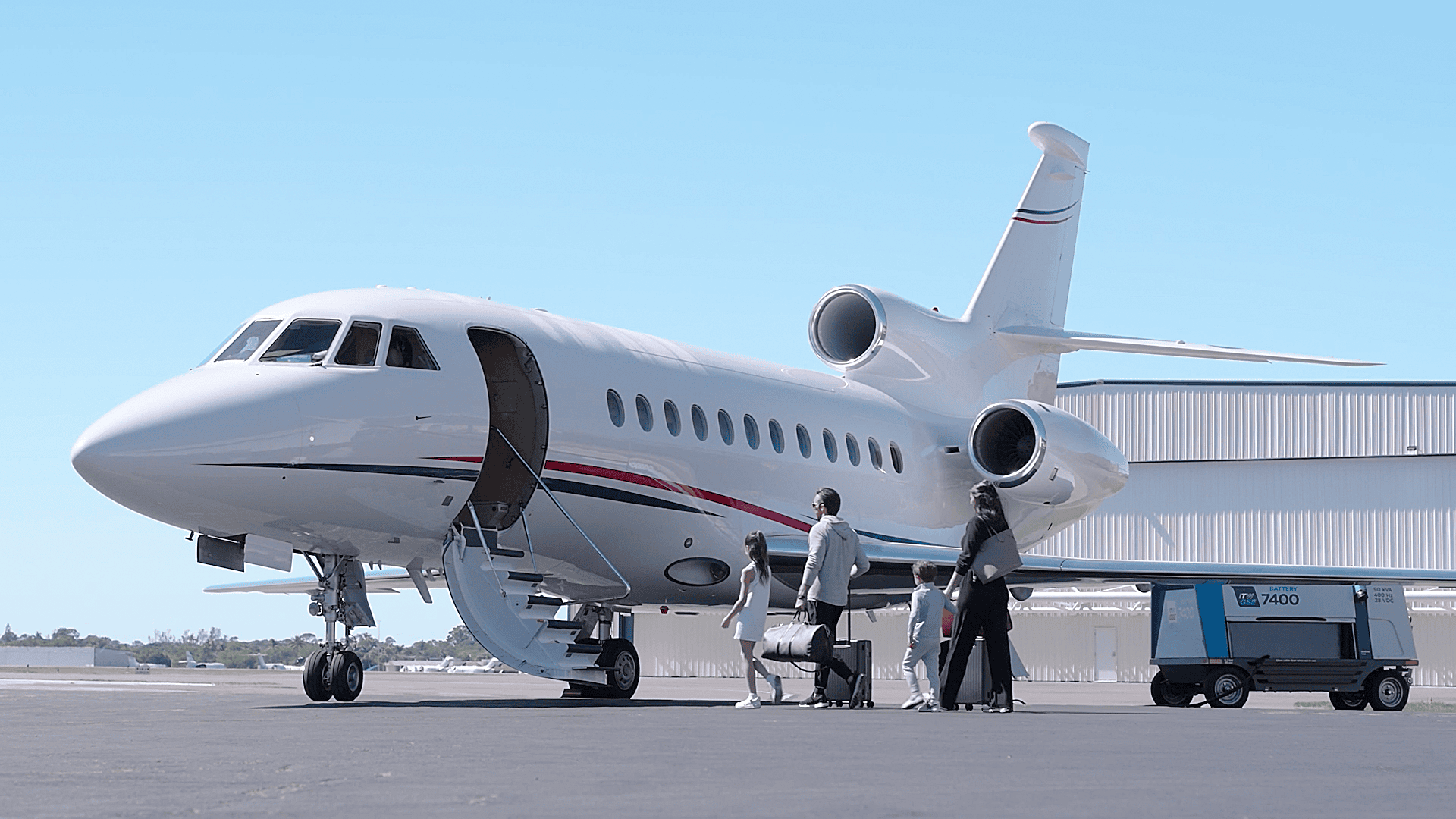 family entering jet and an itw gse 7400 eGPU is supplying the aircraft with power