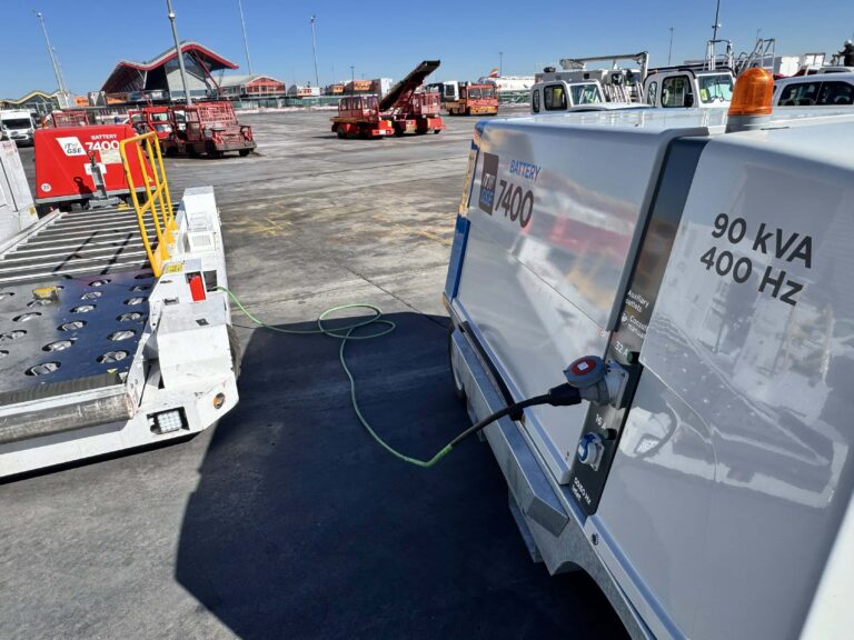 the itw gse 7400 eGPU charging a push-back tractor at a remote stand in an airport.