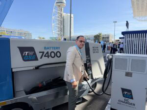 jose de las heras from itw gse standing next to the 7400 battery driven ground power unit with an AUX outlet